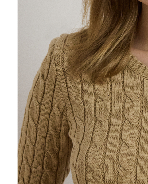 Lauren  Ralph Lauren Lauren updates the classic cable-knit jumper with signature button embellishments on the shoulder and an "LRL"-embroidered logo on the chest. Cut for a slim-fitting silhouette, it's knit from combed cotton for a soft hand.