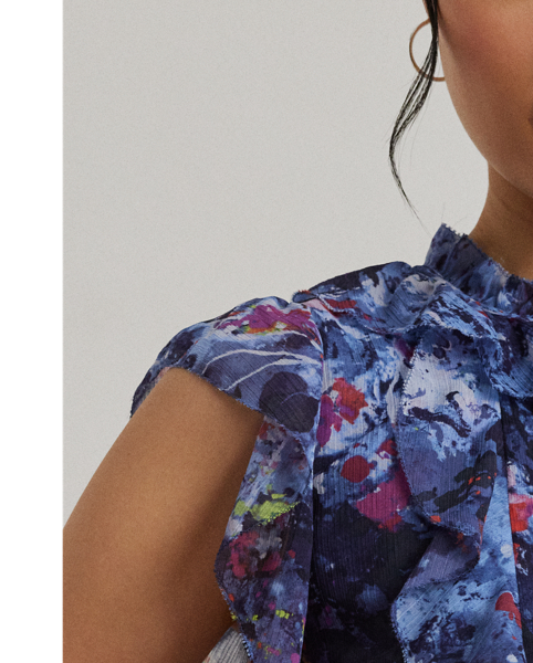 Cascading ruffles, flutter sleeves and crinkle georgette bring an airy look and feel to this tie-neck blouse, which showcases the season's painterly abstract motif.