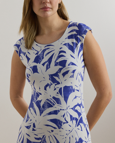 Crafted with smooth stretch jersey for a soft hand and fluid drape, this cap-sleeve dress depicts a palm-frond print in hues of white and blue.