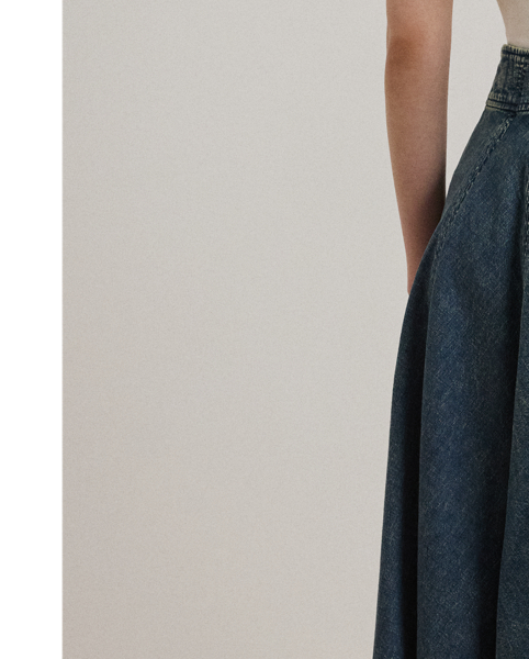 Vertical seams beautifully enhance the A-line silhouette of this denim midi skirt, while a drawcord waist offers effortless appeal.
