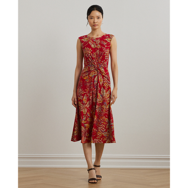 An eye-catching twist-front detail on the bodice serves as the focal point of this cap-sleeve dress, which is crafted from stretch-infused jersey for a soft feel and ease of movement. This version displays a painterly floral motif against a vibrant red backdrop.