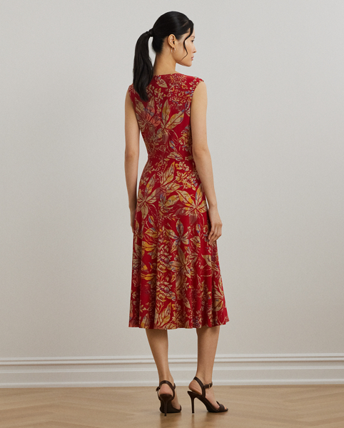 An eye-catching twist-front detail on the bodice serves as the focal point of this cap-sleeve dress, which is crafted from stretch-infused jersey for a soft feel and ease of movement. This version displays a painterly floral motif against a vibrant red backdrop.