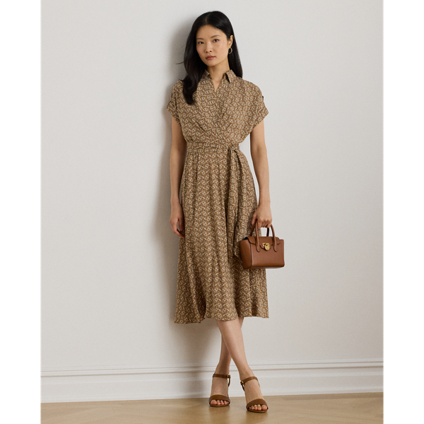 Crafted from airy crepe de chine, this dress balances a spread collar and roll-tab sleeves with a feminine surplice neckline to create a look that is casual yet refined. Detailed with "LRL"-engraved buttons, this version displays a stylised, equestrian-inspired geometric print.