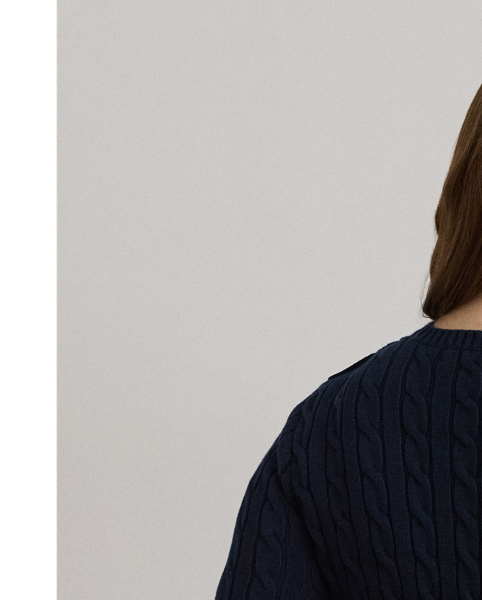 Lauren  Ralph Lauren Lauren updates the classic cable-knit jumper with signature button embellishments on the shoulder and an "LRL"-embroidered logo on the chest. Cut for a slim-fitting silhouette, it's knit from combed cotton for a soft hand.