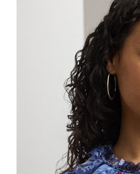 Cascading ruffles, flutter sleeves and crinkle georgette bring an airy look and feel to this tie-neck blouse, which showcases the season's painterly abstract motif.