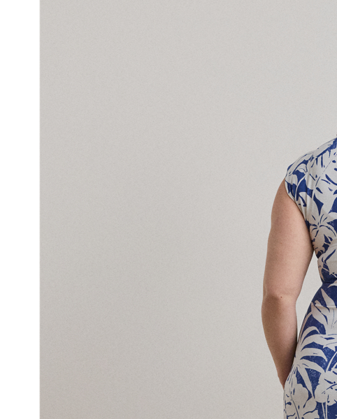 Crafted with smooth stretch jersey for a soft hand and fluid drape, this cap-sleeve dress depicts a palm-frond print in hues of white and blue.