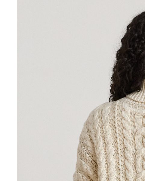 A timeless cold-weather staple, this roll neck jumper showcases a relaxed-fitting, cable-knit silhouette in a soft cotton blend.