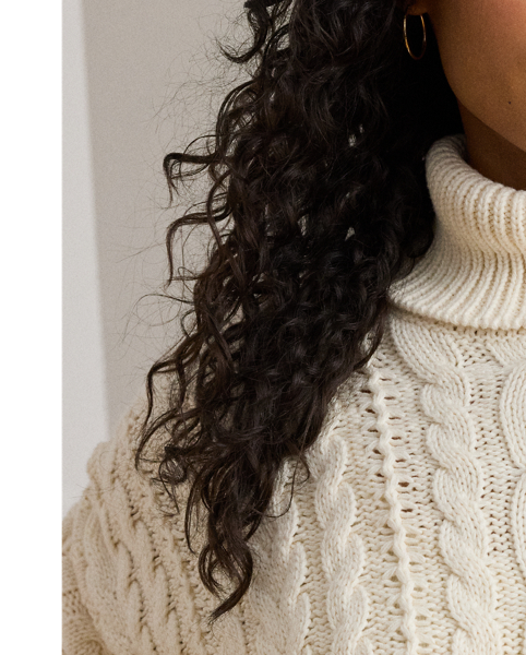 A timeless cold-weather staple, this roll neck jumper showcases a relaxed-fitting, cable-knit silhouette in a soft cotton blend.