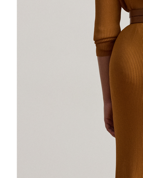 A rib-knit pattern brings subtle dimension to the pencil silhouette of this midi skirt, which is finished with a slit on the side seam for ease of movement.