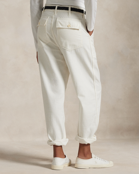 The Ricky Trouser combines smooth cotton sateen with adjustable buttoned tabs on the waist and utility-inspired pocketing. This version has been specially dyed to create distinct nuances in shading, which give each piece a unique character and a slightly faded, timeworn look.
