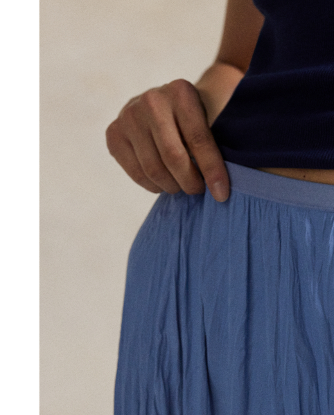 This satin skirt is cut for an A-line silhouette and features an allover crinkled texture.