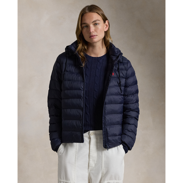 Made with water-repellent fabric, this quilted jacket features an insulating fill and a removable drawstring hood. It packs into its own pocket for easy storage and transport.