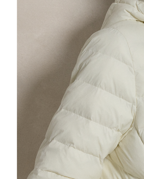 Made with water-repellent fabric, this quilted jacket features an insulating fill and a removable drawstring hood. It packs into its own pocket for easy storage and transport.