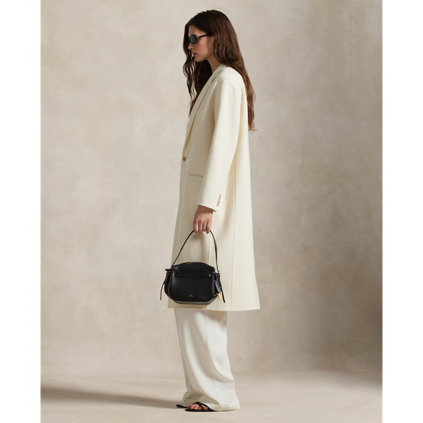 Rendered in double-faced brushed Italian wool for a sumptuous weight and drape, this overcoat is defined by traditional tailoring details. The oversize silhouette features notch lapels, waist darts and menswear-inspired besom pocketing.