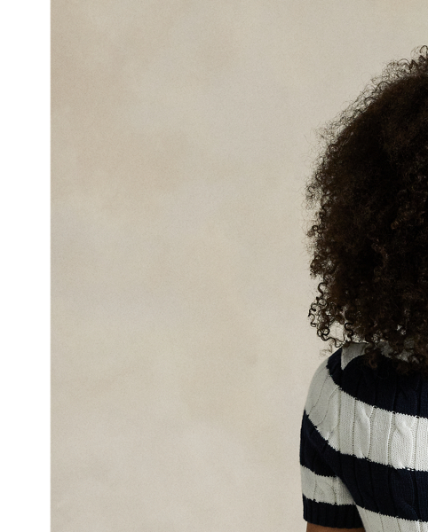 As a boy growing up in the Bronx, Mr Lauren loved going to Yankee Stadium™ to watch his hometown heroes play ball. This cable-knit cotton jumper celebrates Mr Lauren's long-standing love of the Bronx Bombers™ and the game of baseball with a felt patch of the New York Yankees™ logo.