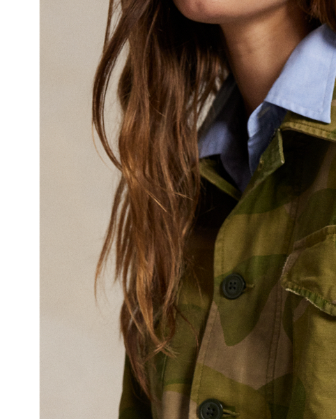 Printed for a surplus-inspired motif, this cotton field jacket balances a cropped silhouette with traditional details, including a buttoned storm placket over a concealed zip closure, shoulder epaulets and patch pockets. The authentic bi-swing construction features a drawstring waist and raw hem.