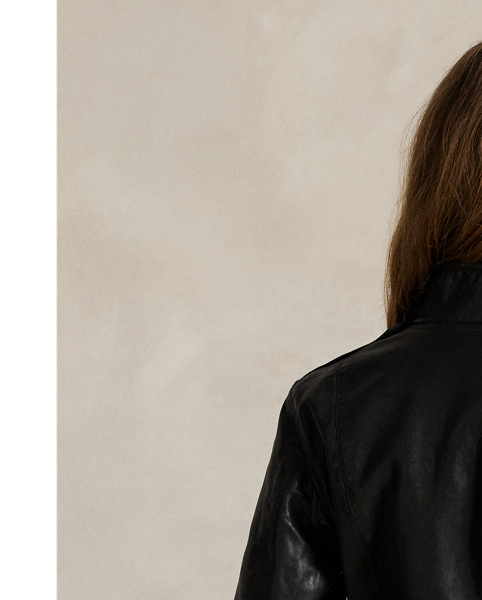 Decorated with silver-tone metal studs, this full-grain leather jacket combines a moto-inspired asymmetrical zip front and buckled self-belt with a slim, structural silhouette.