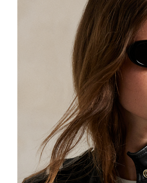 Decorated with silver-tone metal studs, this full-grain leather jacket combines a moto-inspired asymmetrical zip front and buckled self-belt with a slim, structural silhouette.