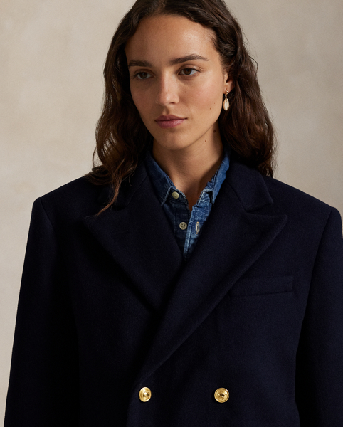 Finely crafted with Italian wool melton, this structured double-breasted jacket is designed with shoulder pads and a partial cupro lining. It's adorned with signature engraved buttons for a heritage-inspired finish.