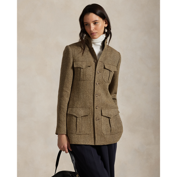Realised in classic herringbone fabric with a blend of linen, silk and wool, this jacket is defined by utility-inspired pocketing and a buttoned throat latch at its mockneck collar.