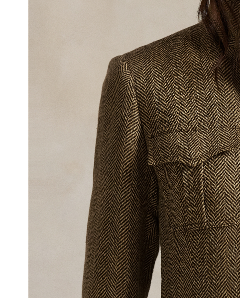 Realised in classic herringbone fabric with a blend of linen, silk and wool, this jacket is defined by utility-inspired pocketing and a buttoned throat latch at its mockneck collar.