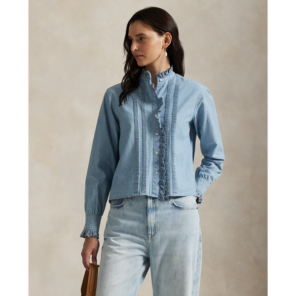 Made with medium-weight Japanese cotton chambray, this shirt is detailed with eyelet-embroidered ruffled trim and pintucking.