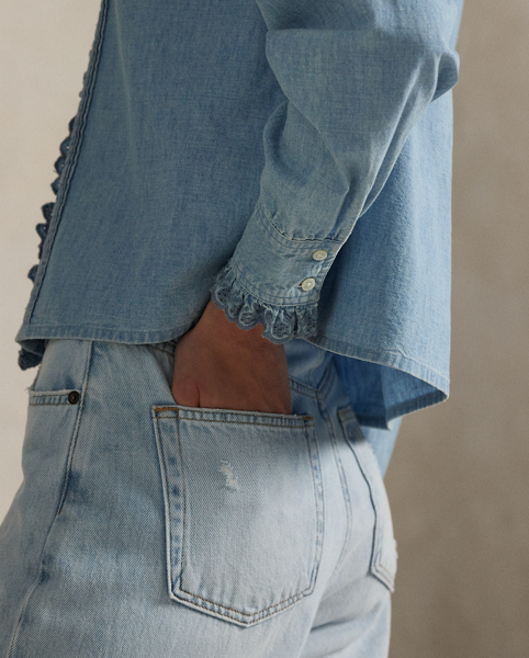 Made with medium-weight Japanese cotton chambray, this shirt is detailed with eyelet-embroidered ruffled trim and pintucking.