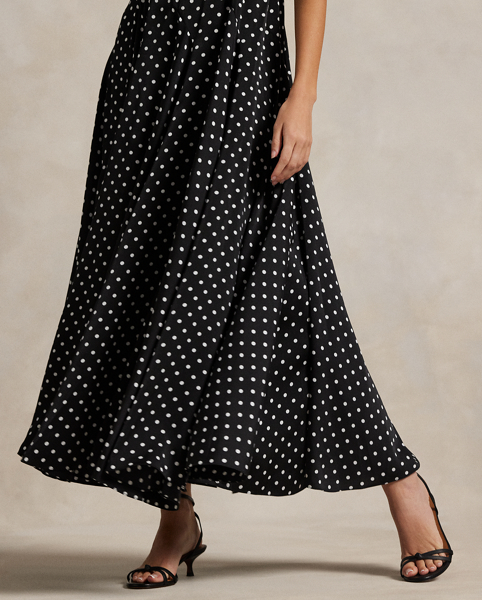 Printed with a polka dot motif, this satin dress combines a fitted seamed bodice with a full skirt for sweeping movement. Adjustable spaghetti straps allow for a personalised fit.
