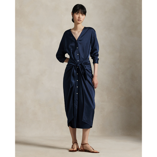 Rendered in soft-falling, lightweight satin, this elegant piece merges classic shirtdress details, like a buttoned placket and pleated back yoke, with a V-neckline and tie-front wrap detail at the waist.
