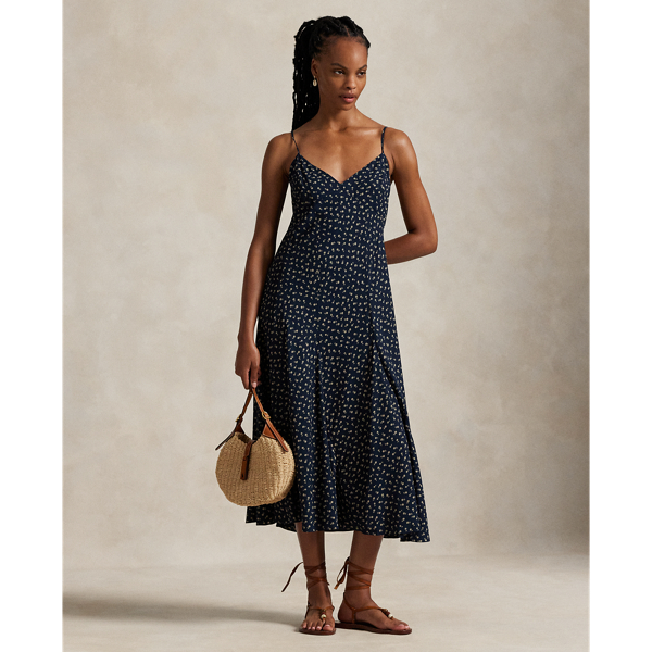 With a sleeveless silhouette reminiscent of a camisole, this flowing A-line dress has a panelled construction and an all-over floral motif.