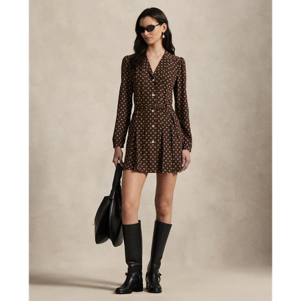 Accented by classic elements like notch lapels and a buttoned placket, this printed dress is crafted with silk crepe for a fluid drape and features a playful silhouette that combines subtle box-pleating and a belted waist.