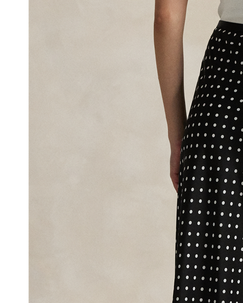 Printed with an all-over polka-dot motif, this satin skirt is cut on the bias for a slightly flared hem, bringing fluid movement to each step.
