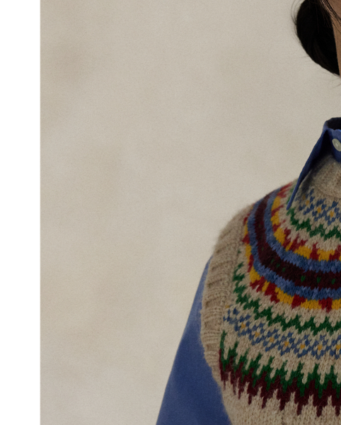Rendered in heavyweight cotton-and-wool blend yarns, this sleeveless jumper combines a wide cable-knit construction and rounded yoke featuring a colourful Fair Isle-inspired motif.