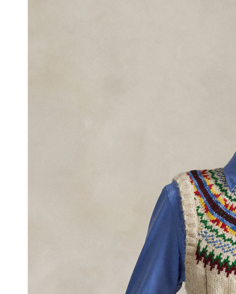 Rendered in heavyweight cotton-and-wool blend yarns, this sleeveless jumper combines a wide cable-knit construction and rounded yoke featuring a colourful Fair Isle-inspired motif.