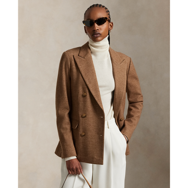 This double-breasted blazer is crafted with medium-weight wool-and-cotton fabric featuring a timeless herringbone weave and a lambskin suede undercollar.