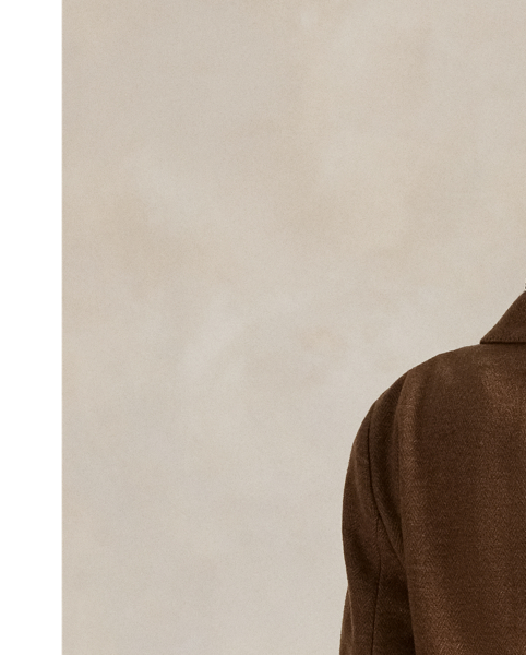 This double-breasted blazer is crafted with medium-weight wool-and-cotton fabric featuring a timeless herringbone weave and a lambskin suede undercollar.