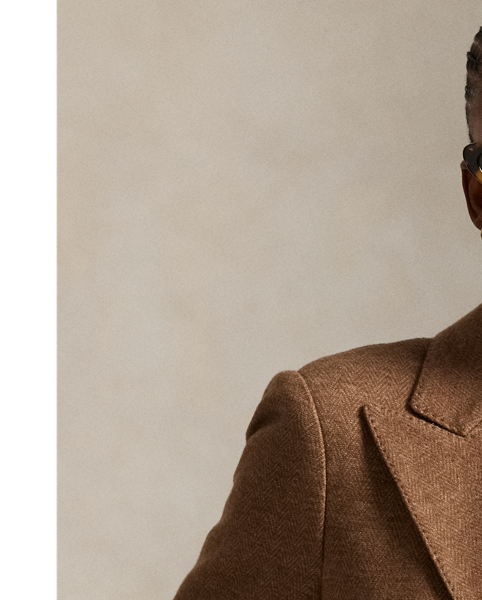 This double-breasted blazer is crafted with medium-weight wool-and-cotton fabric featuring a timeless herringbone weave and a lambskin suede undercollar.