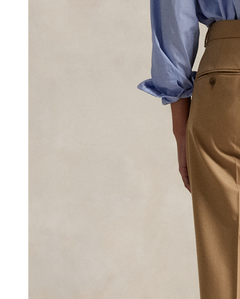 Crafted from a wool blend, these wide-leg trousers feature menswear-inspired details, including a pleated front waist and crisp creases along each leg.