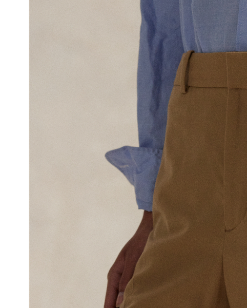 Crafted from a wool blend, these wide-leg trousers feature menswear-inspired details, including a pleated front waist and crisp creases along each leg.