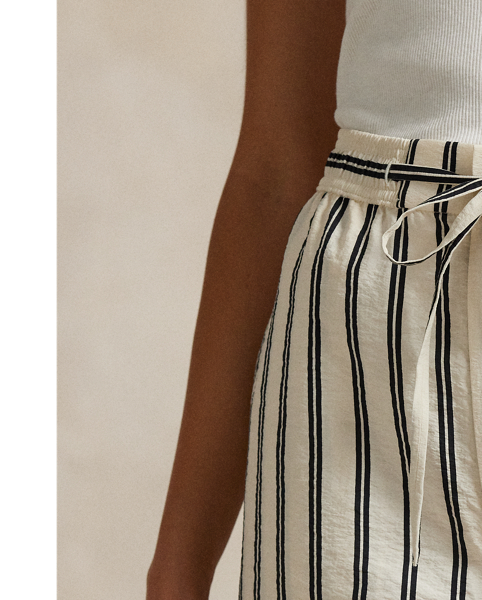 Crafted with a silk blend for an airy, crinkled hand, these trousers feature a clean-lined construction that combines a wide-leg silhouette with vertical stripes and a drawstring detail at the waist.