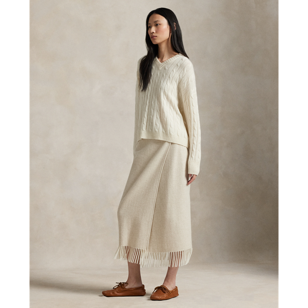 Made with Italian wool-blend herringbone, this wrap skirt is detailed with a one-button closure and fringe trim.