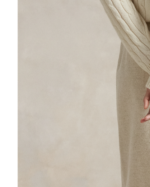 Made with Italian wool-blend herringbone, this wrap skirt is detailed with a one-button closure and fringe trim.