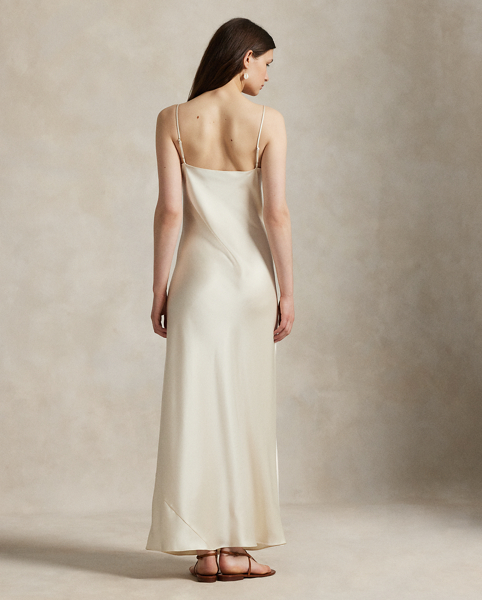 Cut on the bias, this double-faced satin slip dress has an elongated, flared silhouette with a fluid drape and adjustable spaghetti straps for a customisable fit.