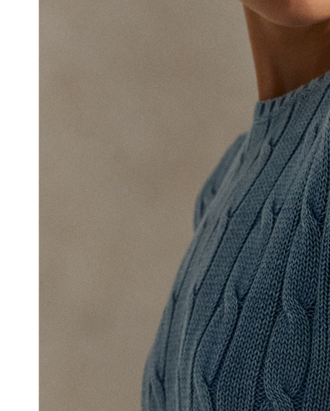 Treated for a high-low effect, this version of our cotton cable-knit jumper features an embroidered motif at the sleeve that unites colourful florals, a dove and  Ralph Lauren Lauren's monogram logo.