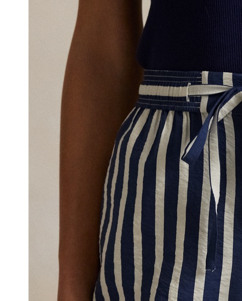 Crafted with a silk blend, these trousers feature a clean-lined construction that combines a wide-leg silhouette with vertical stripes and a drawstring detail at the waist.