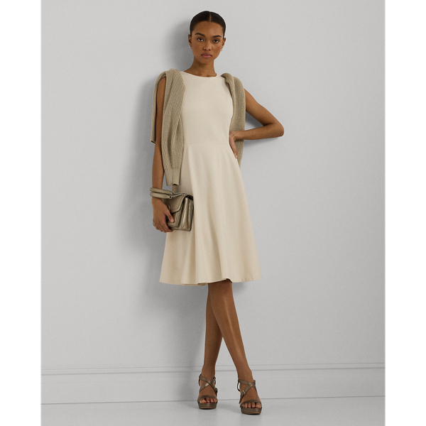 This sleeveless dress is designed with body-shaping princess seams and is crafted with smooth ponte, amplifying its feminine fit-and-flare silhouette.