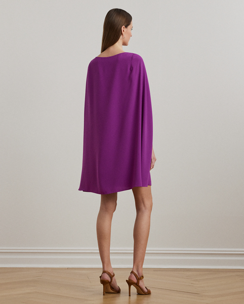 A stylish choice for special occasions, this modern georgette cocktail dress is elevated by a cascading cape, which adds fluid movement to its body-hugging silhouette.