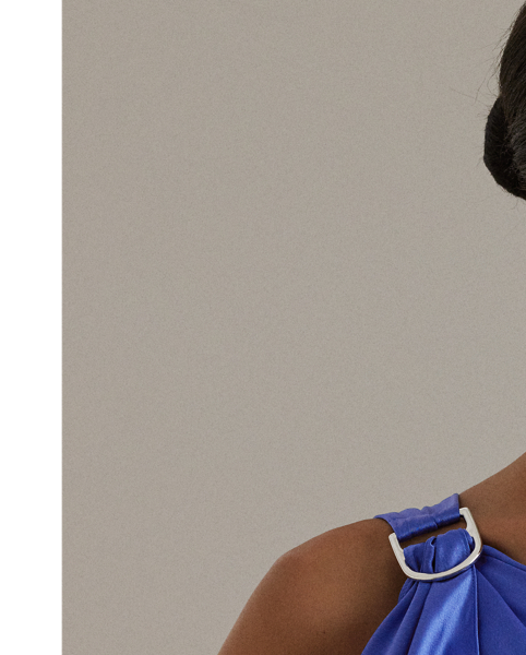 Hammered satin charmeuse gives a beautiful sheen and fluid drape to this one-shoulder gown, which features a delicately draped ruffle that cascades from a buckle at the shoulder.