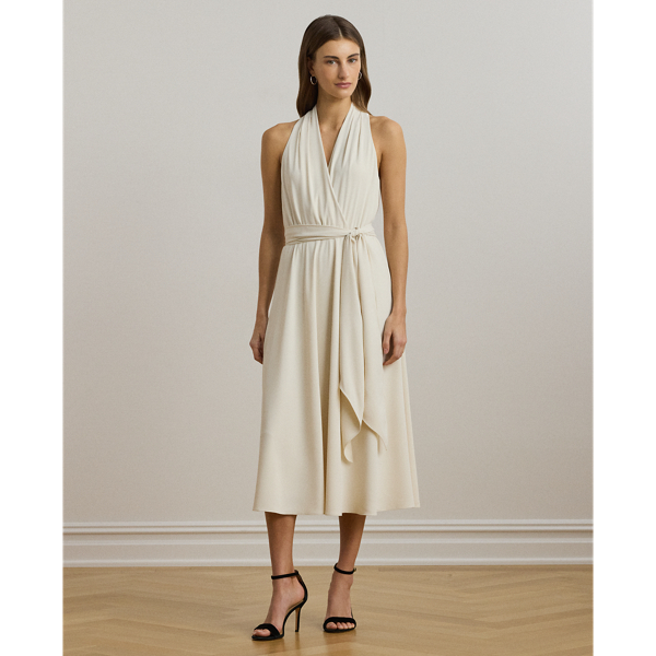 Crafted from airy georgette for an elegant drape, this sleeveless cocktail dress is defined by a halter silhouette and a belted waist. Exuding timeless glamour, it's cut for a calf-grazing midi length and finished with crisp pleats at the shoulders.