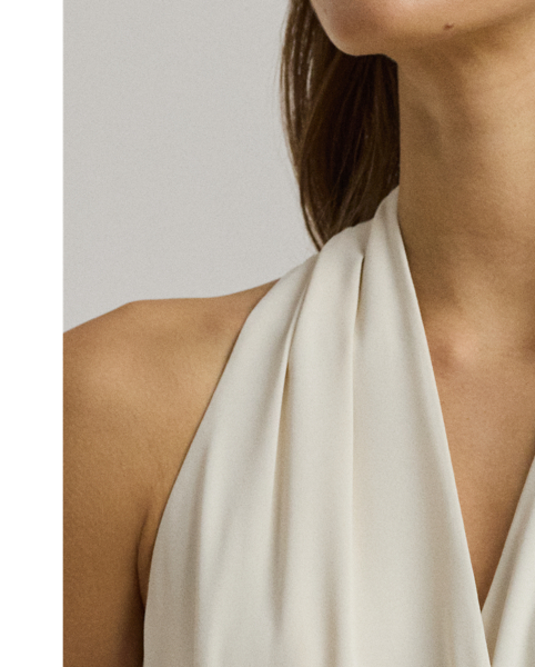 Crafted from airy georgette for an elegant drape, this sleeveless cocktail dress is defined by a halter silhouette and a belted waist. Exuding timeless glamour, it's cut for a calf-grazing midi length and finished with crisp pleats at the shoulders.